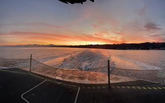 View of sunset from the back of a ferry