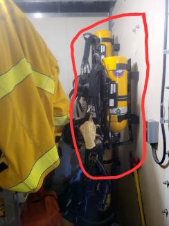 Firefighting equipment with yellow jacket and breathing apparatus tanks