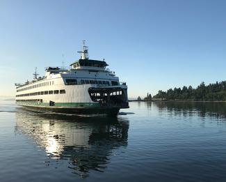 MV Wenatchee sailing on Puget Sound with trees in the background